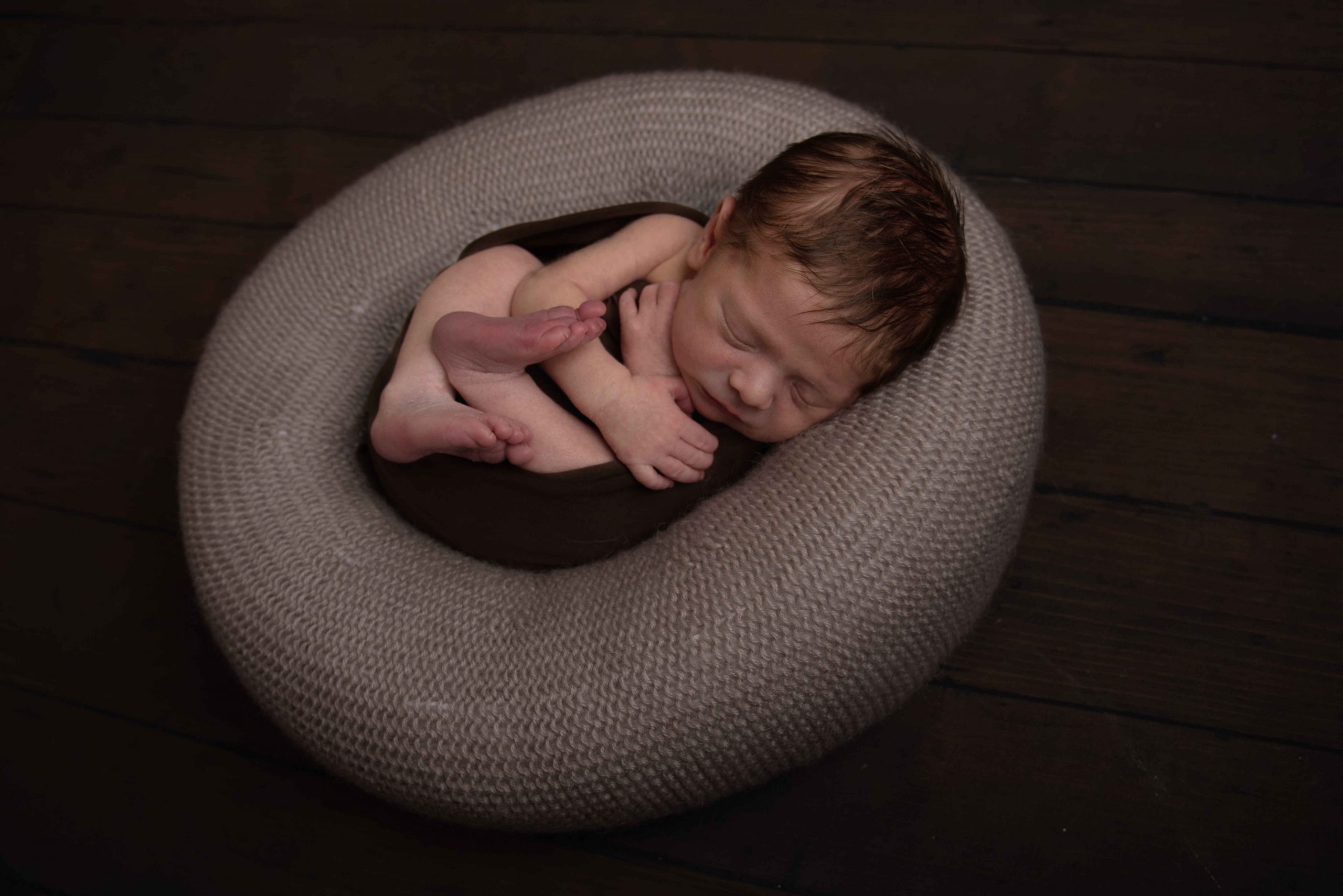 newborn baby boy, wrapped in brown